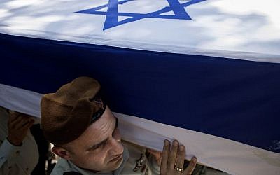 Israeli soldiers carry the coffin of Maj. Tzafrir Bar-Or, 32, one of 13 soldiers who were killed in several separate incidents in Shejaiya on Sunday, at the military cemetery in Holon, Monday, July 21, 2014. . (Photo credit: AP/Dan Balilty)
