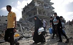 Palestinians salvage possessions at their destroyed houses during a 12-hour cease-fire in Gaza City's Shejaiya neighborhood, Saturday, July 26, 2014.  (AP/Khalil Hamra)