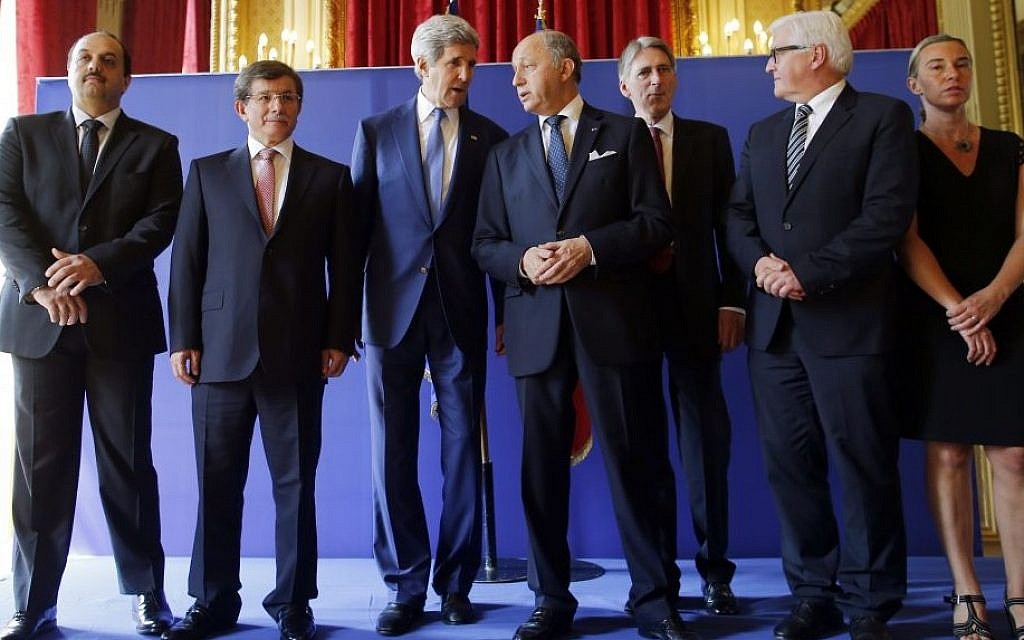 US Secretary of State John Kerry, third from left, stands with from left, Qatari Foreign Minister Khaled al-Attiyah, Turkish Foreign Minister Ahmet Davutoglu, French Foreign Minister Laurent Fabius, British Foreign Secretary Philip Hammond, German Foreign Minister Frank-Walter Steinmeier and Italian Foreign Minister Federica Mogherini after their meeting regarding a cease-fire between Hamas and Israel in Gaza, Saturday, July 26, 2014, at the foreign ministry in Paris, France. (photo credit: AP/Charles Dharapak)