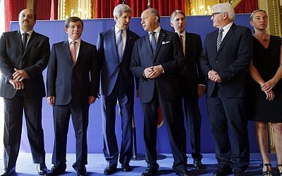 US Secretary of State John Kerry, third from left, stands with from left, Qatari Foreign Minister Khaled al-Attiyah, Turkish Foreign Minister Ahmet Davutoglu, French Foreign Minister Laurent Fabius, British Foreign Secretary Philip Hammond, German Foreign Minister Frank-Walter Steinmeier and Italian Foreign Minister Federica Mogherini after their meeting regarding a cease-fire between Hamas and Israel in Gaza, Saturday, July 26, 2014, at the foreign ministry in Paris, France. (photo credit: AP/Charles Dharapak)