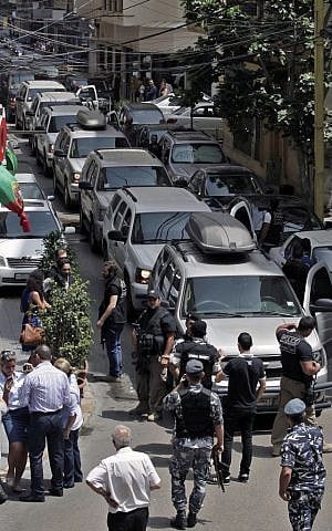 In this Friday, June 20, 2014, file photo, Lebanese police intelligence personnel gather outside a hotel after security forces raided it in Beirut's Hamra district, Lebanon. (photo credit: AP/Bilal Hussein, File)