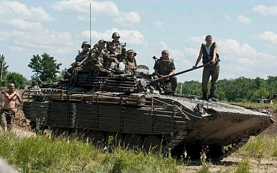 Ukrainian troops atop an APC at a checkpoint near Slovyansk, eastern Ukraine, Saturday, July 5, 2014. (AP Photo/Evgeniy Maloletka)
