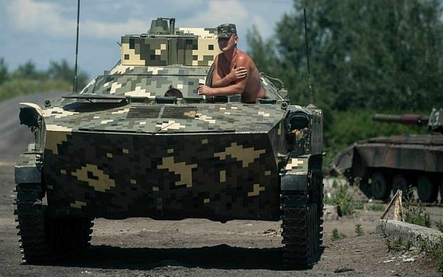 A Ukrainian paratrooper sits in an APC at a checkpoint near Slovyansk, eastern Ukraine, Saturday, July 5, 2014. (AP Photo/Evgeniy Maloletka) A Ukrainian paratrooper sits in an APC at a checkpoint near Slovyansk, eastern Ukraine, Saturday, July 5, 2014. (AP Photo/Evgeniy Maloletka)