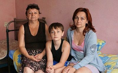 Ludmila Lazaurenko, right, with her son Anatoly and mother Nadezhda Belovol at their temporary housing near Dnepropetrovsk, Ukraine, July 14, 2014.  (Cnaan Liphshiz/JTA)