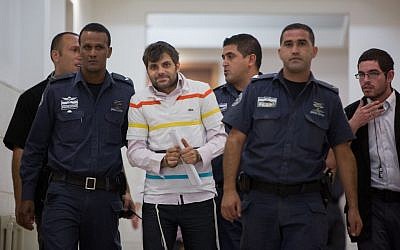 Police escort Yosef Haim Ben-David, one of the Jewish suspects of the murder of Muhammed Abu Khdeir, in the Disctrict Court in Jerusalem (Yonatan Sindel/Flash90)