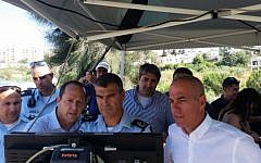 Jerusalem Mayor Nir Barkat (second from left), Chief of Jerusalem Police Yohanan Danino, and Jerusalem  Municipality CEO Amnon Merchav (in white shirt) at the controls of a Bladeworx UAV (photo credit: Courtesy)
