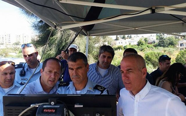 Jerusalem Mayor Nir Barkat (second from left), Chief of Jerusalem Police Yohanan Danino, and Jerusalem Municipality CEO Amnon Merchav (in white shirt) at the controls of a Bladeworx UAV (photo credit: Courtesy) Jerusalem Mayor Nir Barkat (second from left), Chief of Jerusalem Police Yohanan Danino, and Jerusalem Municipality CEO Amnon Merchav (in white shirt) at the controls of a Bladeworx UAV (photo credit: Courtesy)