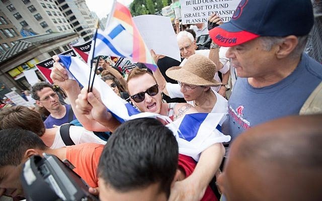 Pro-Israel student activist Brett Loewenstern (center) was extracted by police from a pro-Palestinian 'die-in' on the Boston Common yesterday (photo credit: Elan Kawesch/The Times of Israel)