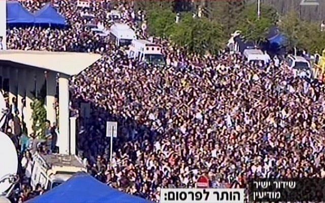 Ambulances carrying the bodies of the three teens making their way through crowds to the Modiin cemetery. (Screen capture: Channel 2) Ambulances carrying the bodies of the three teens making their way through crowds to the Modiin cemetery. (Screen capture: Channel 2)
