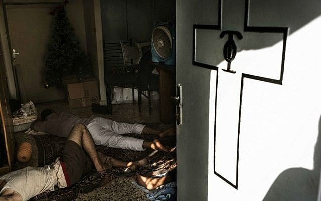 Displaced Palestinians sleep on the floor inside Gaza City's Greek Orthodox church on July 23, 2014 (photo credit: AFP/Marco Longari)_ Displaced Palestinians sleep on the floor inside Gaza City's Greek Orthodox church on July 23, 2014 (photo credit: AFP/Marco Longari)_