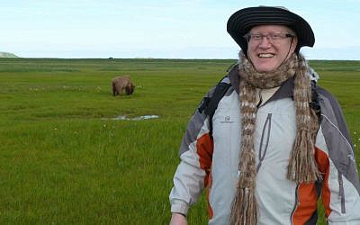 Donn Ungar, who is making aliyah, posing in in Alaska with a grizzly bear in the background. (photo credit: Donn Ungar)
