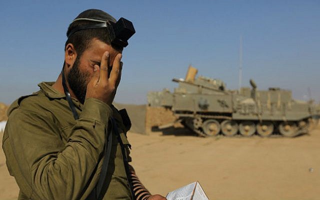 An Israeli soldier prays at an IDF staging area near the Israeli border with Gaza, on July 31, 2014 (photo cropped: Yaakov Naumi/FLASH90) An Israeli soldier prays at an IDF staging area near the Israeli border with Gaza, on July 31, 2014 (photo cropped: Yaakov Naumi/FLASH90)