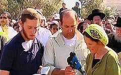 The Fraenkel family reciting kaddish at the funeral for their son Naftali on Tuesday. (Screen credit: Channel 2)