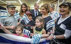 Jewish Agency Chairman Natan Sharansky and former minister of Immigration and Absorption Sofa Landver pose with a family from France, who immigrated to Israel in July 2014. (photo credit: David Salem)