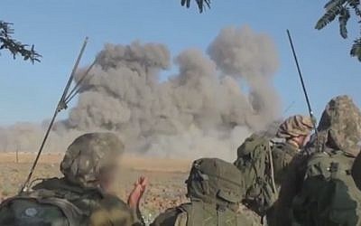 IDF ground troops look on following an Israeli strike in Gaza (screen capture: Youtube)