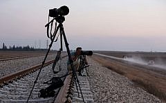 An Israeli press photographer documenting the  movement of IDF forces near the border with Gaza, in southern Israel, on July 23, 2014. (photo credit: Nati Shohat/Flash90)