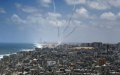 Smoke from rockets fired from near Gaza City is seen after being launched toward Israel, on July 15, 2014. (photo credit: AFP/Thomas Coex)
