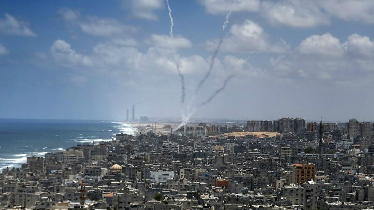Smoke from rockets fired from near Gaza City is seen after being launched toward Israel, on July 15, 2014 (photo credit: AFP/ Thomas Coex) Smoke from rockets fired from near Gaza City is seen after being launched toward Israel, on July 15, 2014 (photo credit: AFP/ Thomas Coex)