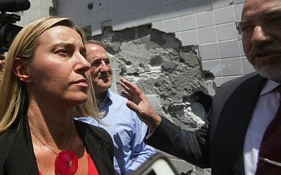 Italian Foreign Minister Federica Mogherini (C), along with Israeli Foreign Minister Avigdor Lieberman (R), visits the southern Israeli port city of Ashdod, on July 15, 2014 (photo credit: AFP/David Buumovitch)