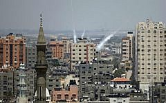 Smoke from rockets fired from Gaza City is seen after being launched toward Israel, on July 15, 2014 ( photo credit: AFP/ Thomas Coex)