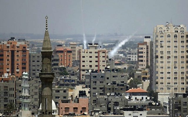 Smoke from rockets fired from Gaza City is seen after being launched toward Israel, on July 15, 2014 ( photo credit: AFP/ Thomas Coex) Smoke from rockets fired from Gaza City is seen after being launched toward Israel, on July 15, 2014 ( photo credit: AFP/ Thomas Coex)