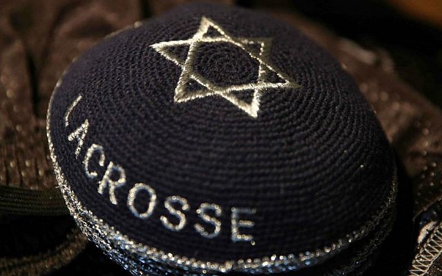 A stack of traditional Jewish skullcaps bear the words 'Israel Lacrosse,' part of the Israeli Lacrosse team's gear, Commerce City, Colorado,  July 15, 2014. (photo credit: AP/Brennan Linsley)