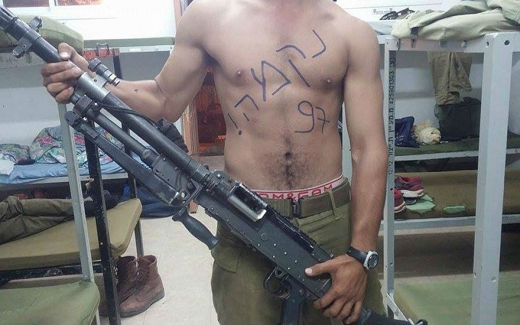 A soldier poses with a gun, with the word "revenge" written on his chest (The Nation of Israel Demands Vengeance! Facebook page) A soldier poses with a gun, with the word "revenge" written on his chest (The Nation of Israel Demands Vengeance! Facebook page)