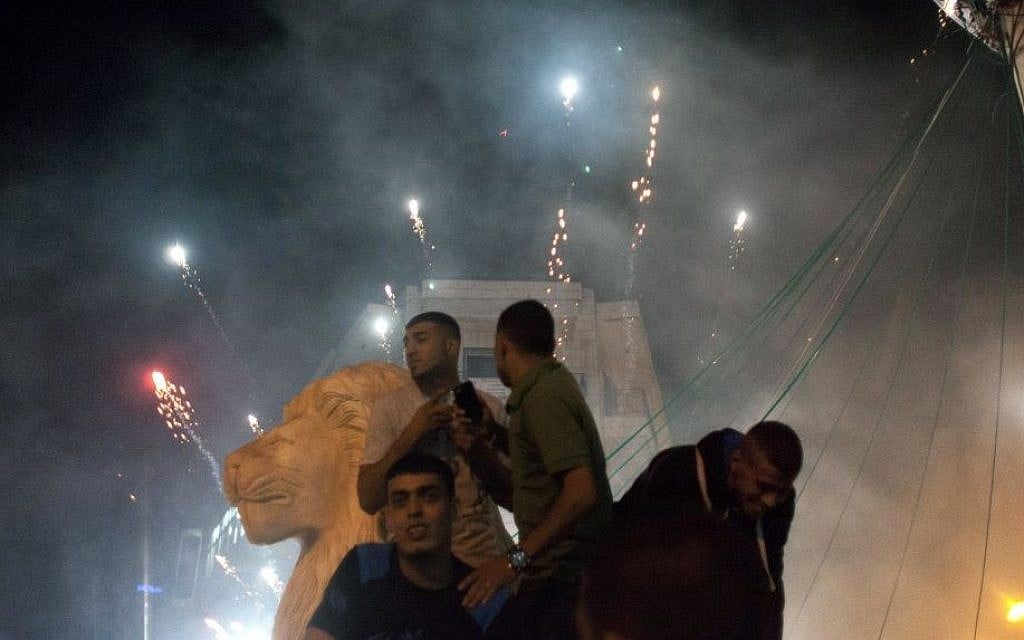 Palestinians launch fireworks during celebrations in the West bank city of Ramallah, late Sunday, July 20, 2014. (photo credit: AP Photo/Nasser Nasser)