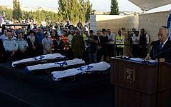 President Shimon Peres delivering a eulogy next to the flag-draped bodies of Naftali Fraenkel, Gil-ad Shaar and Eyal Yifrach at their funeral July 1, 2014 (photo credit: Chaim Tzach)