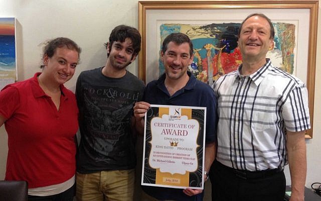 Michael Gillette (second from right) receives certificate of achievement from Ulpan-Or staff Gavi Lewy-Neuman (left), Dor Yerushalmi and Yoel Ganor. (Photo credit: Renee Ghert-Zand)