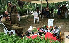 Friends and fellow soldiers at Yuval Heiman's gravesite after his funeral on Tuesday. (Courtesy)
