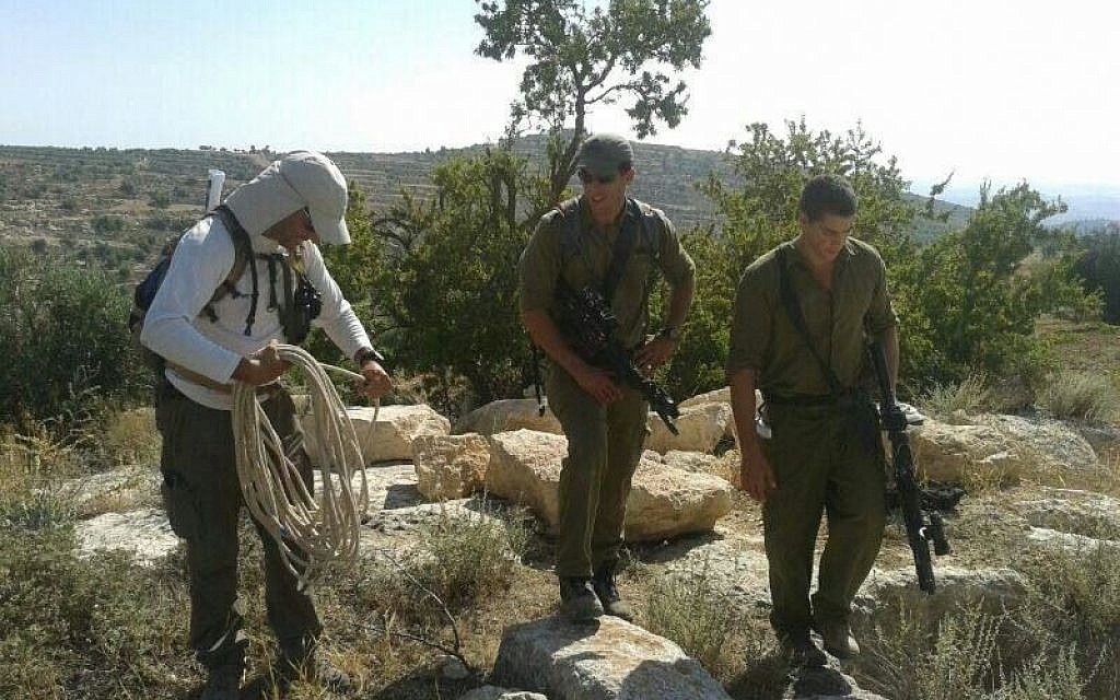 Hovav Landau, left, along with two soldiers in the Halhul region Monday (photo credit: Binyamin Tropper/ courtesy) Hovav Landau, left, along with two soldiers in the Halhul region Monday (photo credit: Binyamin Tropper/ courtesy)