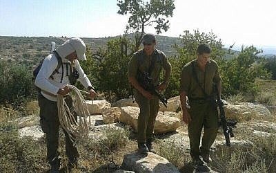 Hovav Landau, left, along with two soldiers in the Halhul region Monday (photo credit: Binyamin Tropper/ courtesy)