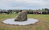 A small crowd attends the dedication ceremony of a monument at the Jewish cemetery in Rychwal, Poland. (Ruth Ellen Gruber/JTA)