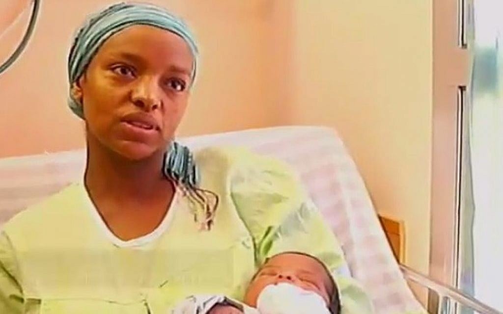 Galaitu Kshaun, widow of slain IDF soldier Bayhesain Kshaun, speaks to Channel 2, Thursday, July 31, 2014, with her new daughter in her arms. Sgt.-Maj. Kshaun was killed by Hamas gunmen when they emerged from a tunnel inside Israel last week. (photo credit: screen capture)