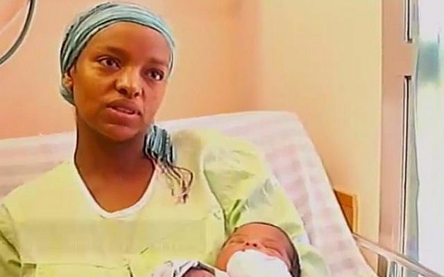 Galaitu Kshaun, widow of slain IDF soldier Bayhesain Kshaun, speaks to Channel 2, Thursday, July 31, 2014, with her new daughter in her arms. Sgt.-Maj. Kshaun was killed by Hamas gunmen when they emerged from a tunnel inside Israel last week. (photo credit: screen capture) Galaitu Kshaun, widow of slain IDF soldier Bayhesain Kshaun, speaks to Channel 2, Thursday, July 31, 2014, with her new daughter in her arms. Sgt.-Maj. Kshaun was killed by Hamas gunmen when they emerged from a tunnel inside Israel last week. (photo credit: screen capture)