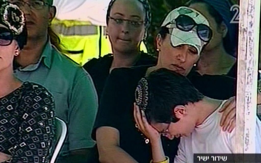 Relatives of Gil-ad Shaar mourning at the funeral in Talmon Tuesday. (Screen capture: Channel 2) Relatives of Gil-ad Shaar mourning at the funeral in Talmon Tuesday. (Screen capture: Channel 2)