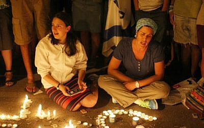 In this June 30, 2014 photo, citizens are seen lighting candles at the hitchhiking site in the West Bank from where three young Jewish teenagers, Eyal Yifrach, Naftali Fraenkel and Gilad Sha'ar were abducted on June 12 (photo credit: Jonathan Sindel/Flash90)