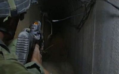 A soldier leading journalists through a tunnel in Khan Yunis (screen capture: Walla! News)