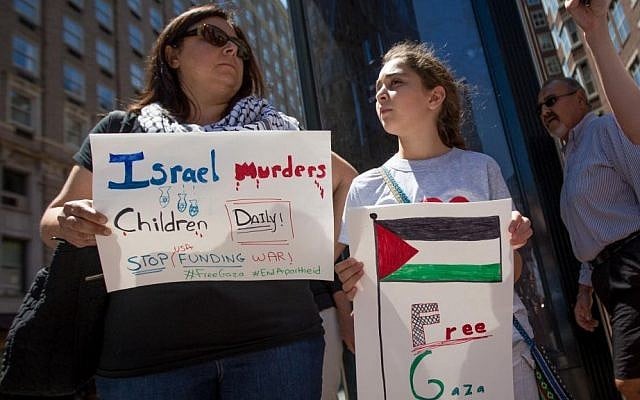 Zeina Othman, whose family is from Jerusalem, protests against Israel with her daughter outside the Israeli consulate on Friday (photo credit: Elan Kawesch/The Times of Israel)