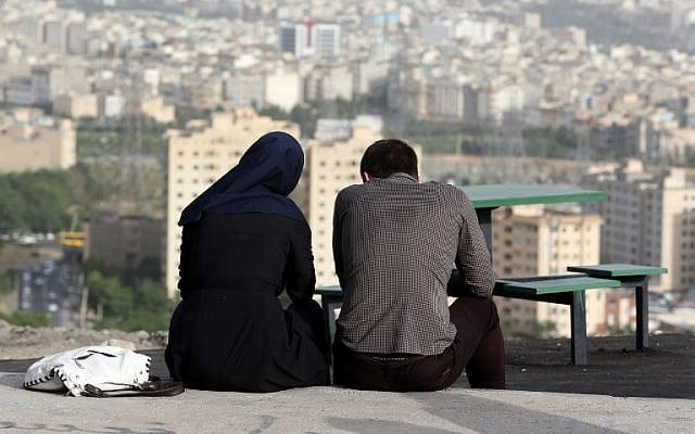 An Iranian couple sit together in the northwestern Shahran neighbourhood overlooking Tehran on June 7, 2014. (photo credit: AFP Photo/Atta Kenare) 