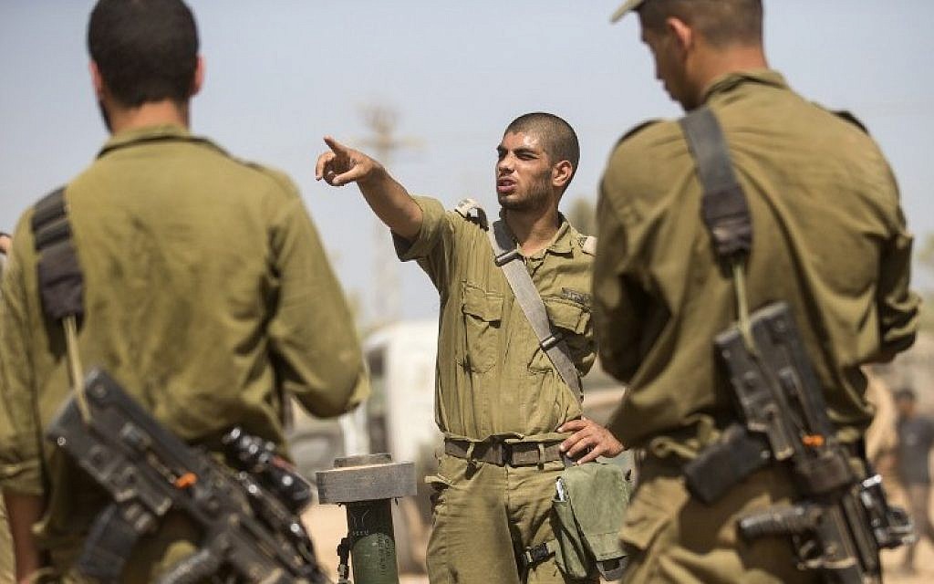 Israeli soldiers take part in a briefing at an army deployment area on the southern Israeli border with the Gaza Strip Friday, August 1, 2014. (photo credit: Jack Guez/AFP) Israeli soldiers take part in a briefing at an army deployment area on the southern Israeli border with the Gaza Strip Friday, August 1, 2014. (photo credit: Jack Guez/AFP)