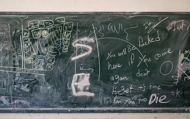 Some military instructions in Hebrew and a map of a school are seen on a blackboard after Israeli soldiers withdrew from the Beit Hanun High school for girls Tuesday, on August 5, 2014. (photo credit: Marco Longari/AFP)