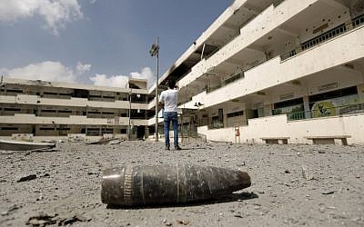 A shell lies on the ground at the heavily damaged Sobhi Abu Karsh school in Gaza City's Shejaiya neighborhood, a Hamas stronghold, Tuesday, August 5, 2014. (photo credit: Mohammed Abed/AFP)