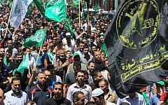 Illustrative photo of Palestinian protesters waving Hamas and Islamic Jihad flags as they take part in a demonstration is support of Gaza in the West Bank (AFP/HAZEM BADER).
