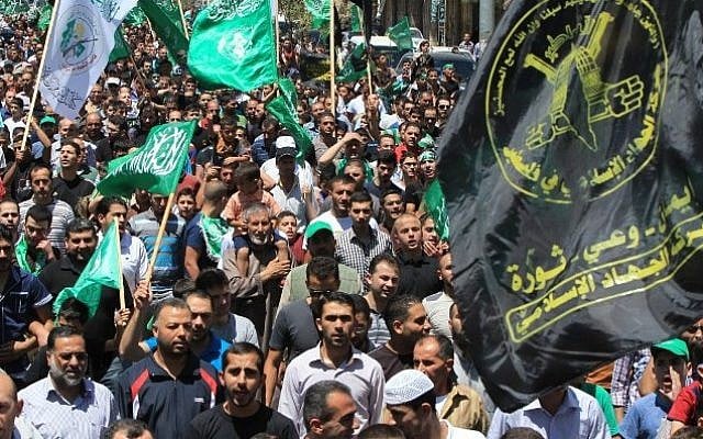 Illustrative photo of Palestinian protesters waving Hamas and Islamic Jihad flags as they take part in a demonstration in support of Gaza in the West Bank (AFP/HAZEM BADER)