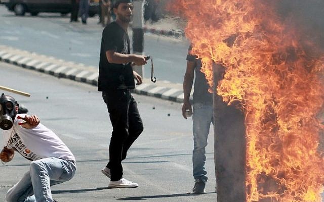 Palestinian protesters clash with Israeli security forces (unseen) following a demonstration in support of Gaza after Friday prayers in the West Bank town of Bethlehem on August 8, 2014. (photo credit: Musa Al Shaer/AFP)