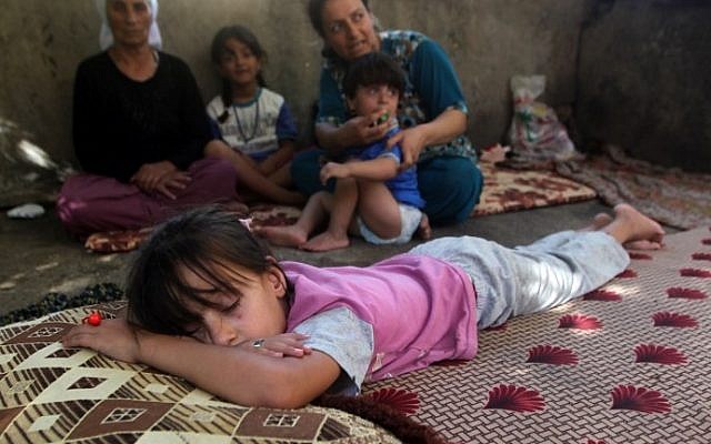 A child sleeps as Iraqi Yazidis, who fled their homes when Islamic State militants attacked the town of Sinjar, sit in a building where they found refuge in the Kurdish city of Dohuk in Iraq's autonomous Kurdistan region, August 10, 2014. (AFP/Ahmad al-Rubaye) A child sleeps as Iraqi Yazidis, who fled their homes when Islamic State militants attacked the town of Sinjar, sit in a building where they found refuge in the Kurdish city of Dohuk in Iraq's autonomous Kurdistan region, August 10, 2014. (AFP/Ahmad al-Rubaye)