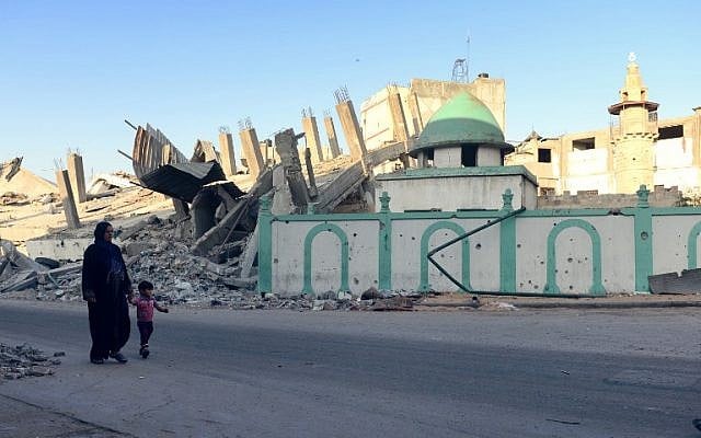 A Palestinian woman and a child walk past the destroyed Omari mosque on August 12, 2014 in Jabaliya, northern Gaza Strip. (photo credit: AFP PHOTO/ROBERTO SCHMIDT) A Palestinian woman and a child walk past the destroyed Omari mosque on August 12, 2014 in Jabaliya, northern Gaza Strip. (photo credit: AFP PHOTO/ROBERTO SCHMIDT)