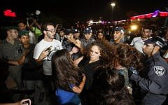 An Israeli supporter of the right-wing Lehava organization scuffles with police during a demonstration outside the wedding hall where Morel Malka, who was born Jewish, and Mahmoud Mansour, an Arab Israeli, are getting married on August 17, 2014 in Rishon Letzion. (AFP/Gali Tibbon)